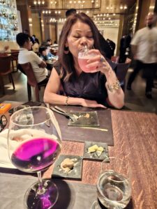 Farida can be seen taking a sip of a cocktail at The Cut in Singapore.