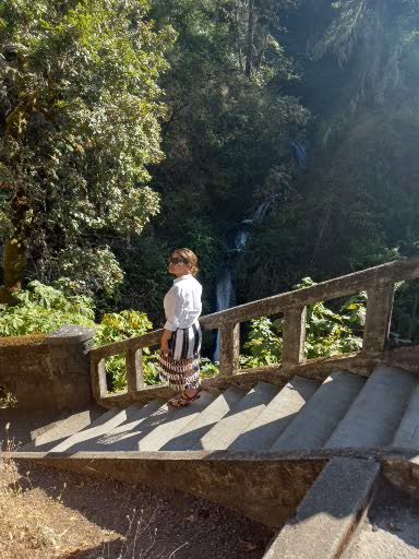 Farida can be seen here while descending steps down to a waterfall.