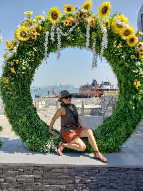Farida is posing inside of a giant reef at Empire Outlet shopping mall on Staten Island NYC.