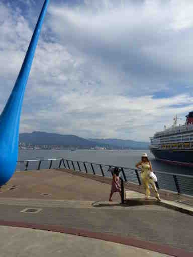Farida posing at the Raindrop sculpture at the harbour area of Vancouver Canada. It is called The Drop. The sculpture was created by Inges Idee
