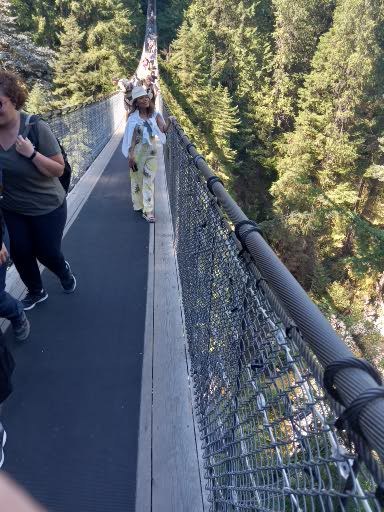 Farida is posing on the Capilano Suspension Bridge.