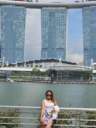 Farida can be seen posing at Marina Bay in Singapore with marina Sands Hotel in the background.